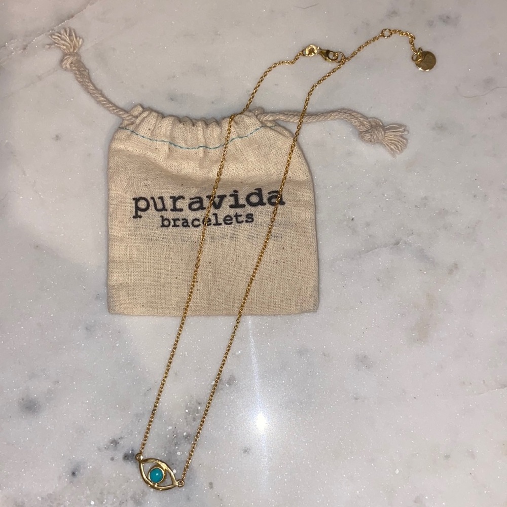 Brand new Pura Vida necklace. Gold with eye symbol at the bottom.